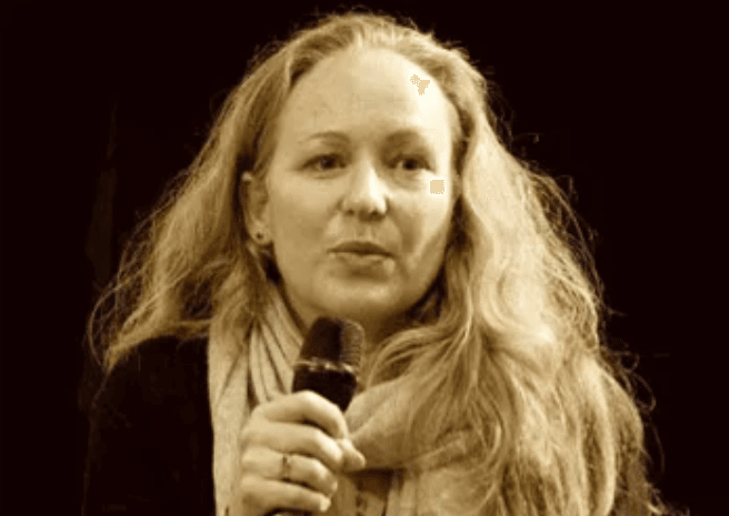 Nora Bateson speaking into a microphone