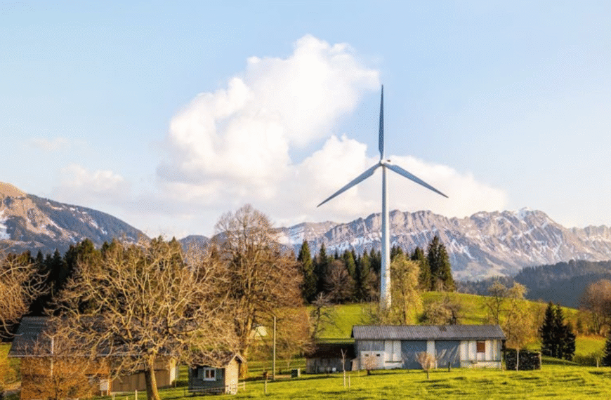 mountains scenery with trees, clouds, and wind turbines.